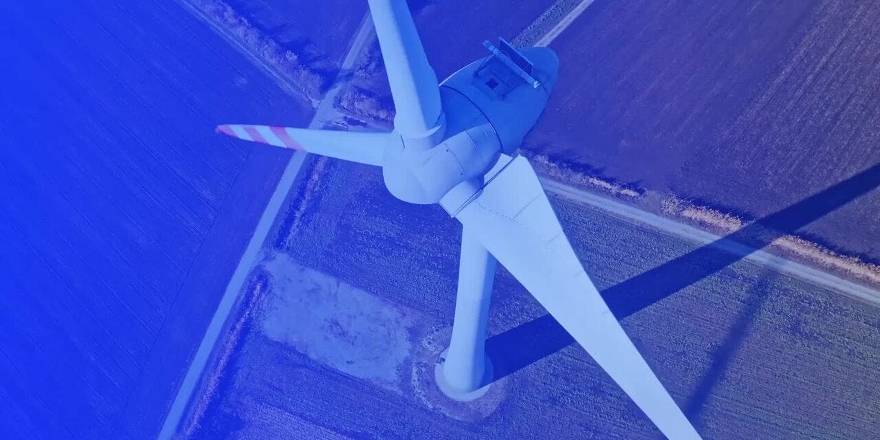 Wind turbine in a field with a blue overlay