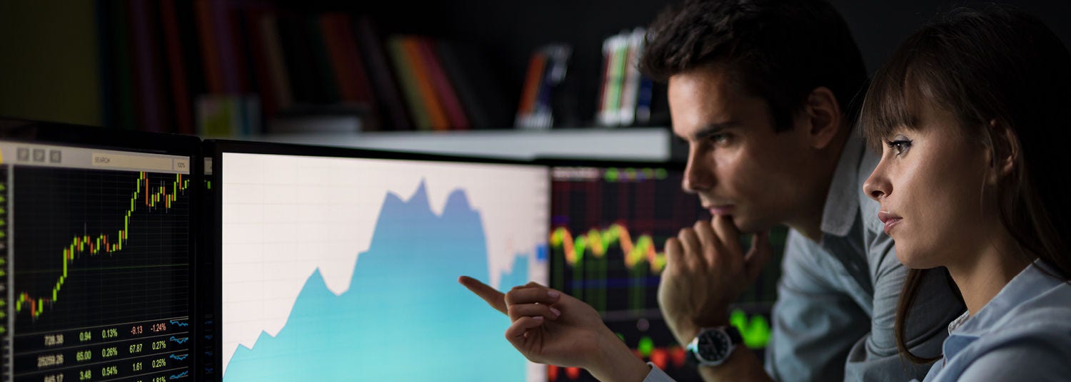 2 persons watching graphs