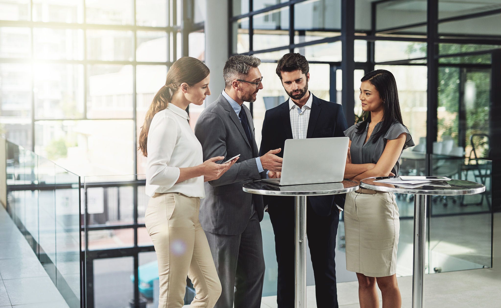People, business and laptop in office with collaboration, meeting and planning for company project. Financial analysts, corporate and technology with teamwork, strategy and agenda for investment deal