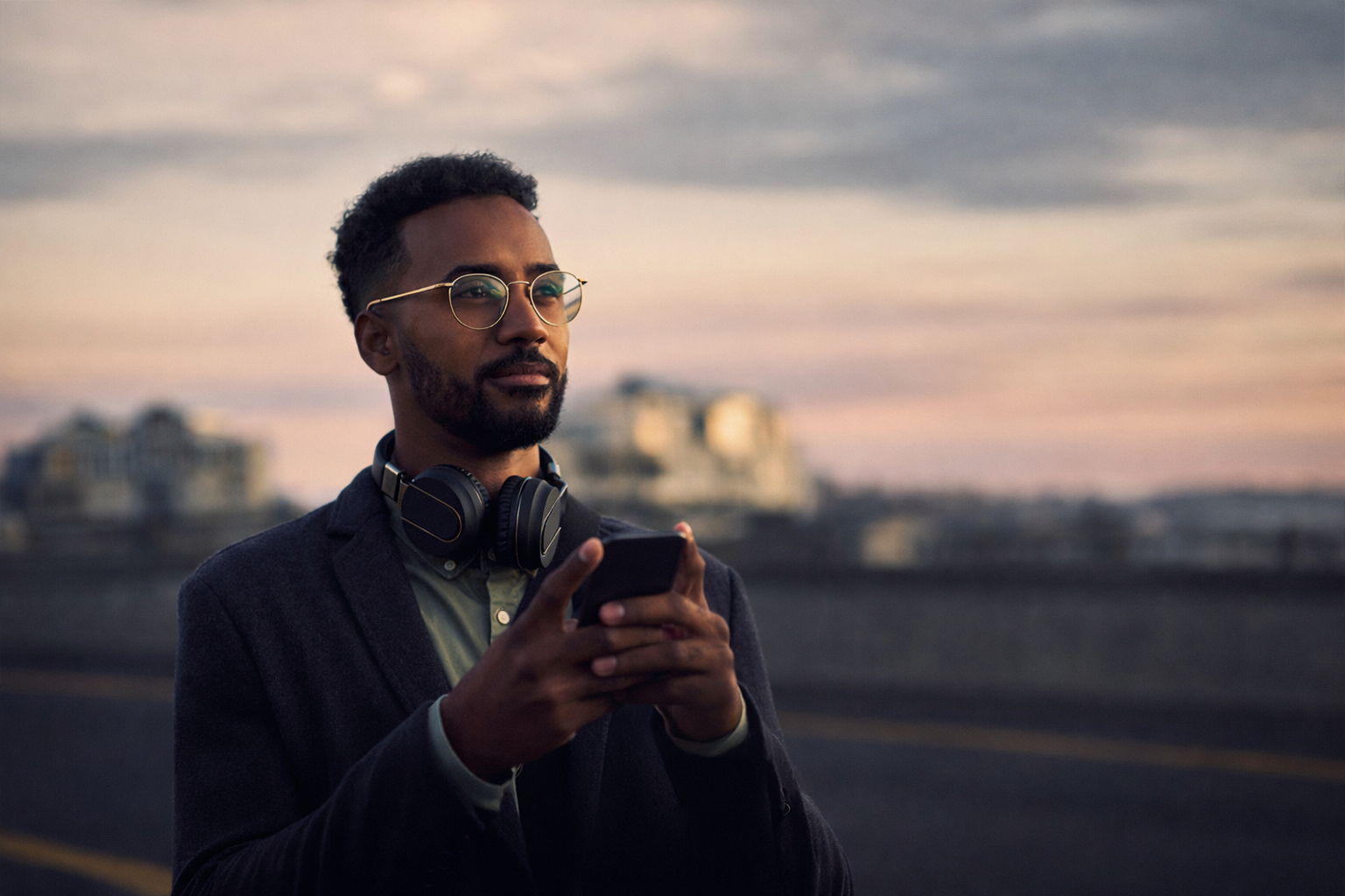 man holding his phone looking forward